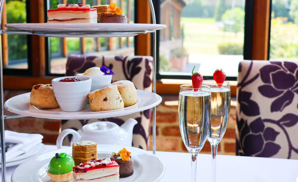 Afternoon tea with glasses of prosecco in the Kings Restaurant at Old Thorns Hotel & Resort
