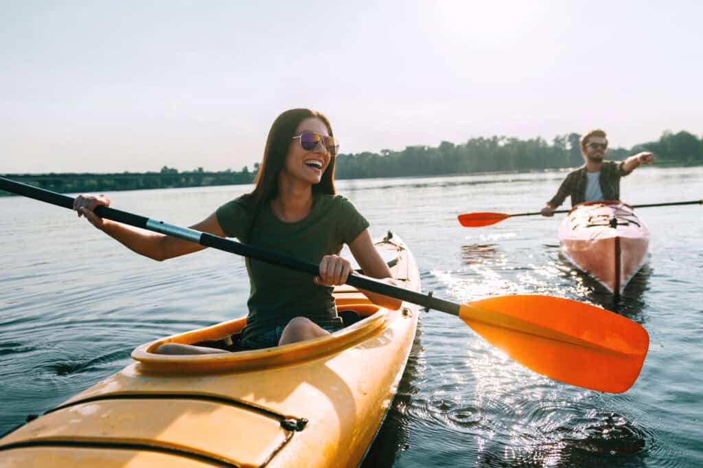 Kayaking at Old Thorns with friends on a sunny day, showcasing outdoor leisure and water sports.