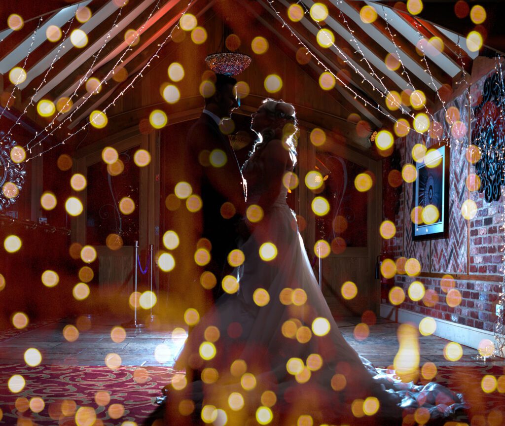 Wedding couple surrounded by fairy lights