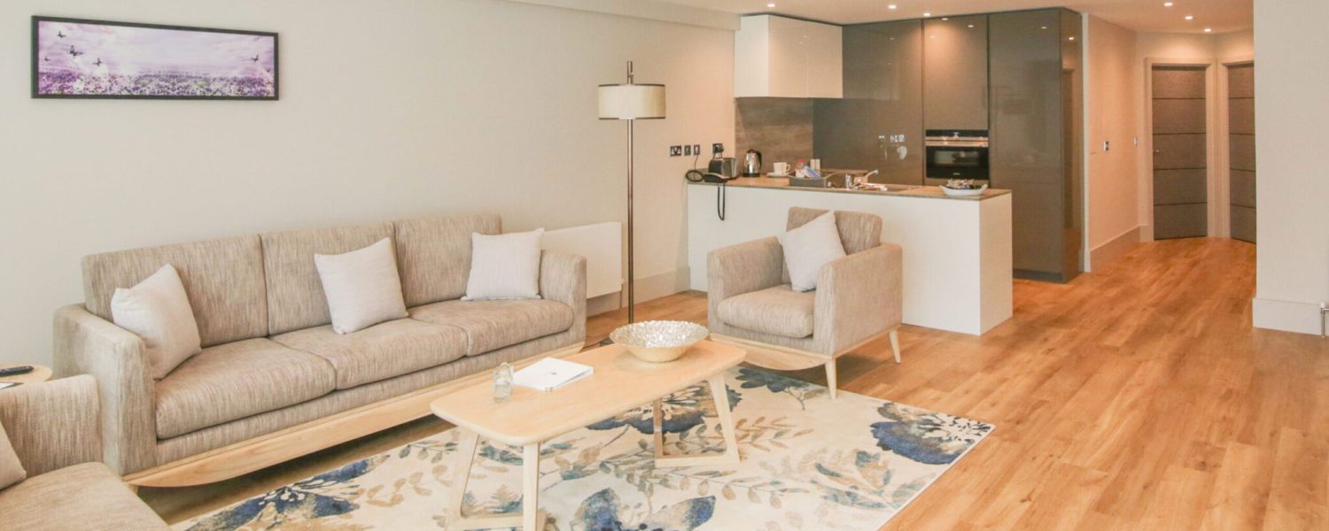 Living space in 2 Bedroom residence apartment showing seating and kitchen