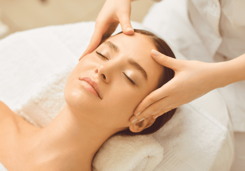 Lady receiving a head massage from a team member in the spa