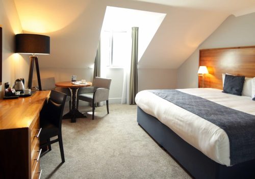 Superior Hotel bedroom with bed, TV, desk and chair at Old Thorns Hotel & Resort