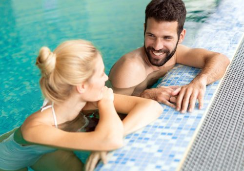 Happy married couple relaxing at wellness spa resort